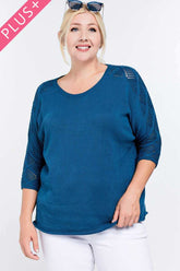 Plus size teal knit top with lace sleeves, styled with white pants and sunglasses