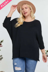 Plus size black ribbed sweater with 3/4 sleeves, paired with ripped jeans and a tan hat