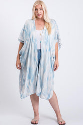 Plus size woman wearing blue and white tie-dye kimono over white top and jeans