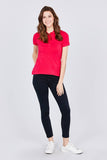 Woman wearing red polo shirt with black jeans and white sneakers, stylish plus size outfit