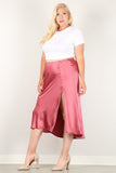 Plus size woman in pink satin midi skirt with front slit and buttons, paired with white top and heels