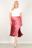Plus size satin midi skirt with side slit and button detail, styled with white crop top