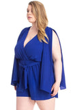 Royal blue plus size romper with wrap front, tie waist, and cape sleeves for women