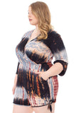 Plus size woman in tie-dye wrap romper with 3/4 sleeves and side tie detail