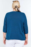 Blue ribbed knit top with 3/4 sleeves for plus size women, paired with white pants