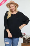 Plus size black knit top with lace sleeves, paired with ripped jeans and a tan hat