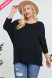 Plus size black ribbed sweater with 3/4 sleeves, paired with ripped jeans and a tan hat