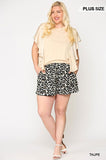 Plus size woman in taupe top and leopard print shorts