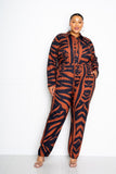Plus size woman in orange and navy tiger print jumpsuit with buttons and drawstring waist