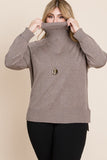 Plus size woman wearing cozy taupe turtleneck sweater with gold pendant necklace